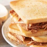 A close-up photo of the slow cooker pulled pork on toasted bread.
