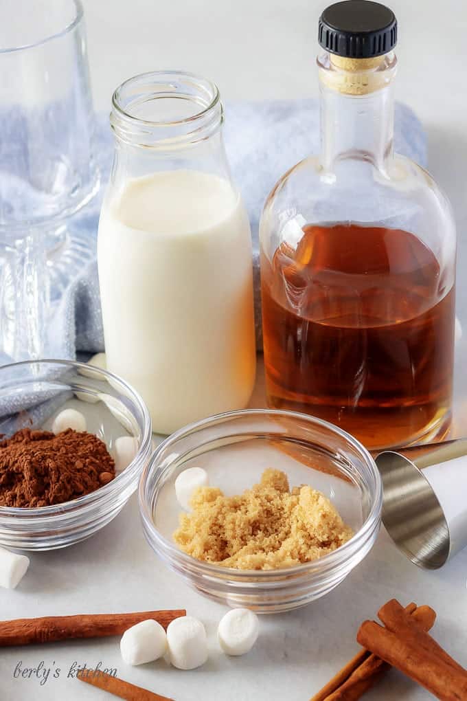 A photo of the spiked hot chocolate ingredients, like bourbon, brown sugar, and cocoa powder.