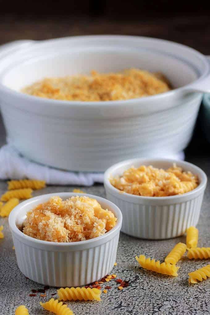 A photo of the finished baked macaroni and cheese seved in two white ramekins.