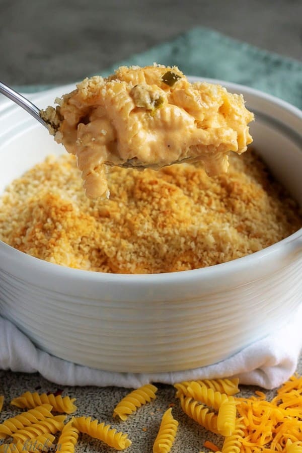 A large photo of the baked macaroni and cheese being scopped out of the baking dish.