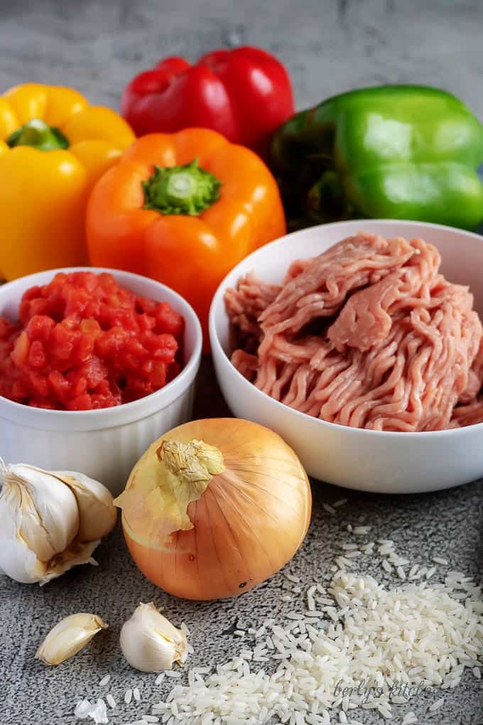 Ground turkey, bell peppers, garlic, tomatoes, onion, and rice used for ground turkey stuffed bell peppers.