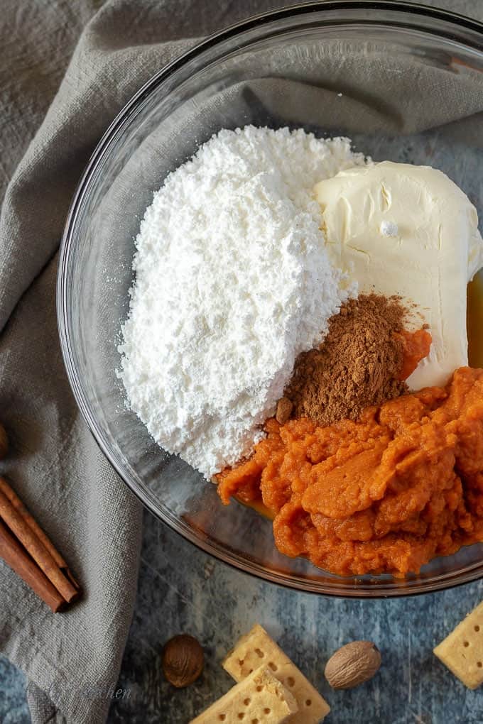 All of the pumpkin dip ingredients in a large mixing bowl, ready to be mixed.