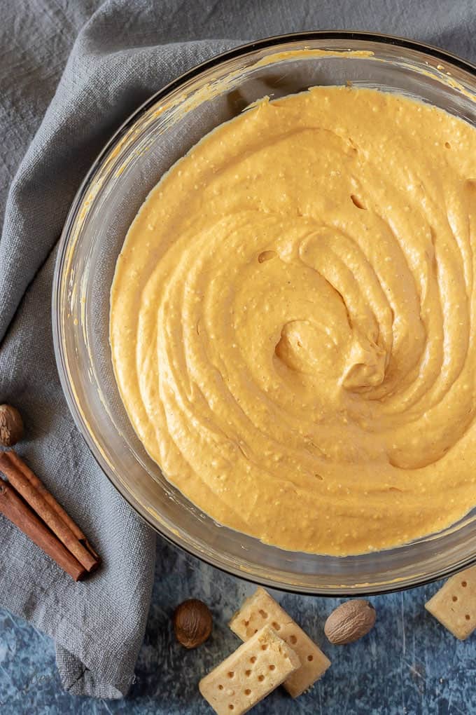 The mixed pumpkin dip in a large glass bowl, ready to be transferred to a serving dish.