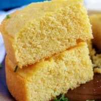 Two pieces of buttermilk cornbread stacked on top of each other.