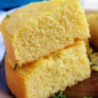 Two pieces of buttermilk cornbread stacked on top of each other.