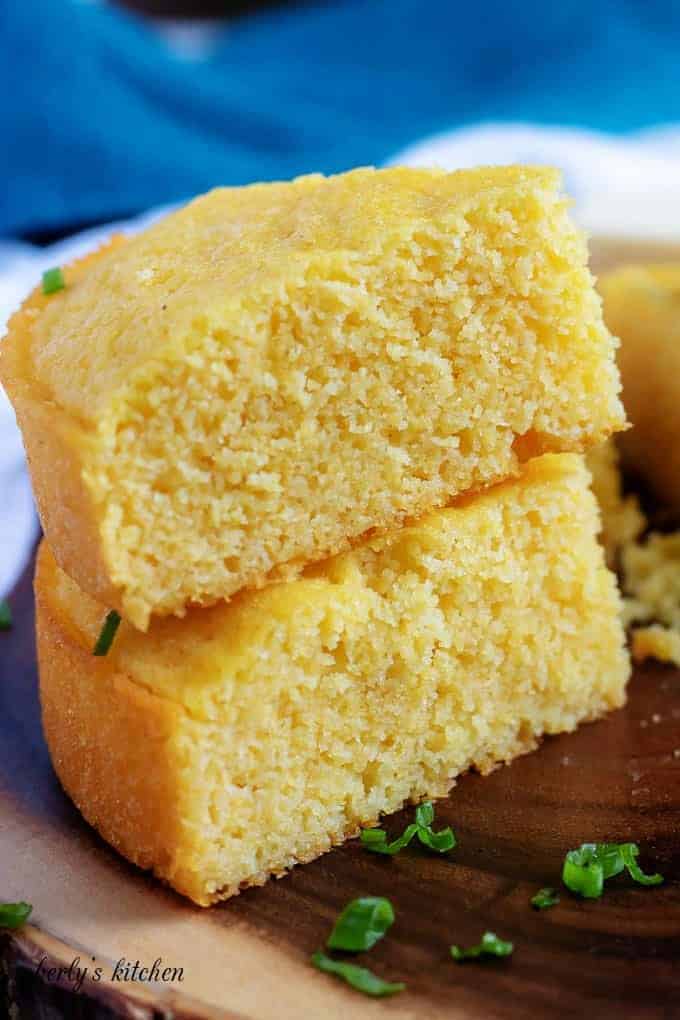 Two pieces of buttermilk cornbread stacked on top of each other.