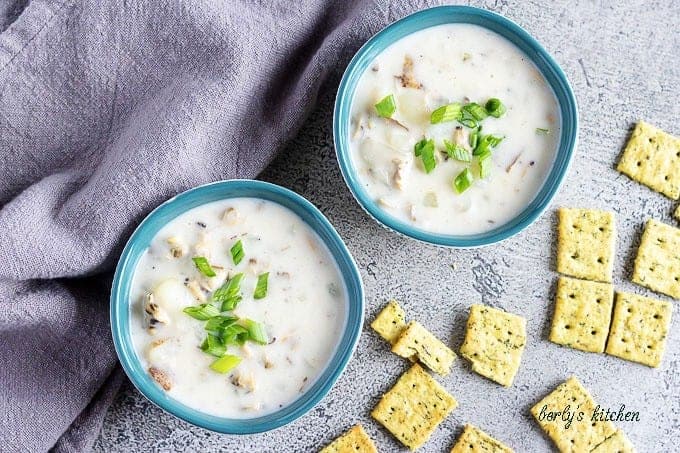 An aerial shot of the clam chowder in bowls, topped with green onion.