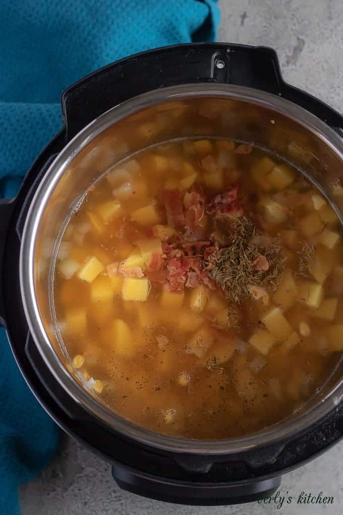 Aerial view of the ingredients in the pressure cooker ready to be sealed and cooked.