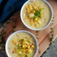 A top-down shot of the corn chowder with bacon, topped with diced green onions.