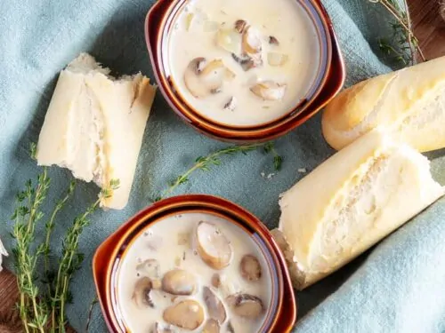 A top-down picture of the finished easy mushroom soup in brown earthen ware bowls.