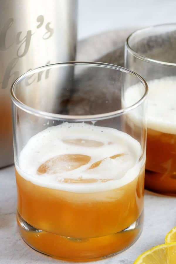 Close-up photo of the finished gold rush cocktail served on the rocks in a cocktail glass.