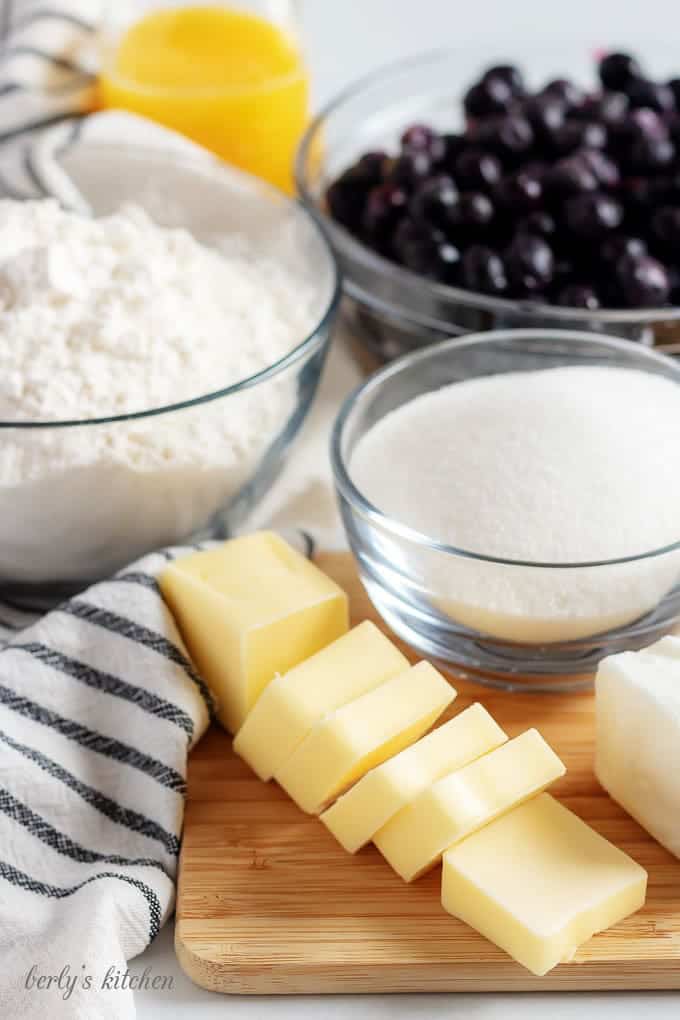 The blueberry pie recipe ingredients like flour, sugar, and blueberries.