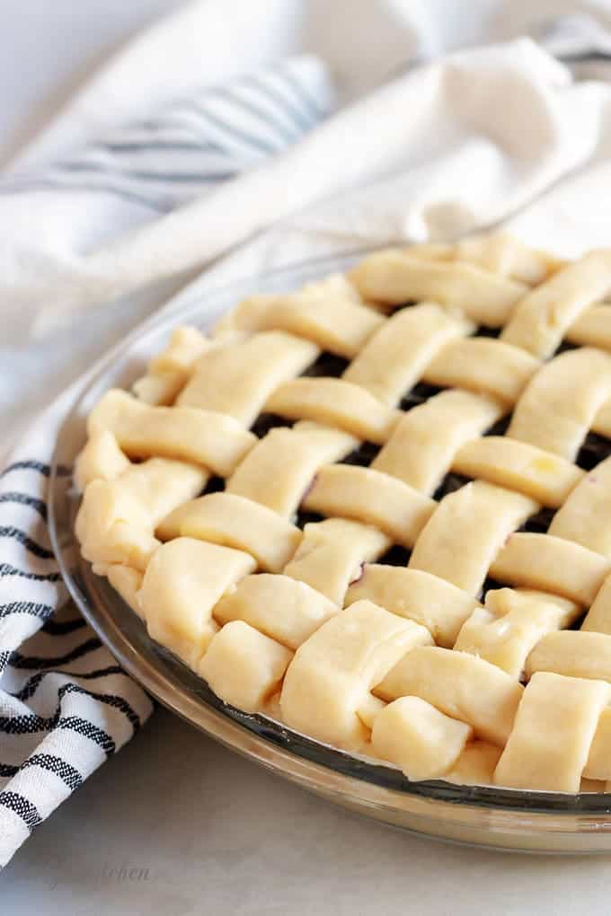 An angled picture of the pie with the lattice crust just before it goes in the oven.