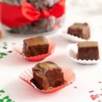 Several pieces of Bourbon Caramel Fudge next to Christmas confetti.