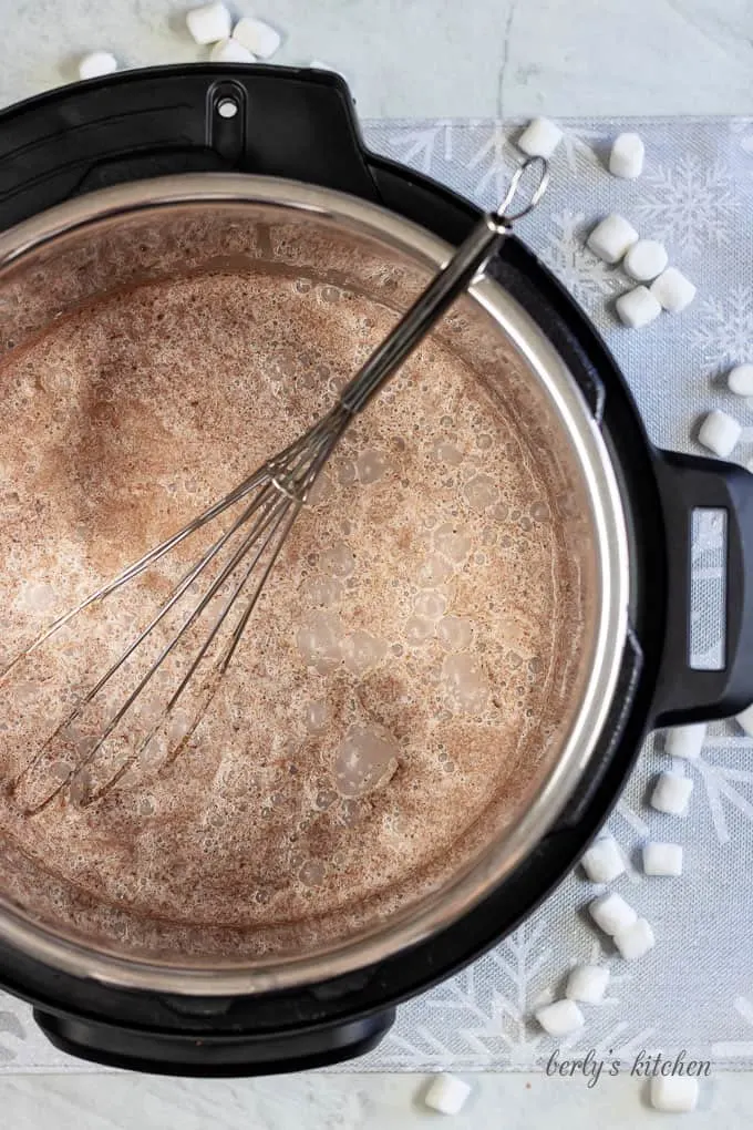 Top down view of Instant Pot Hot Cocoa in the Instant Pot with a whisk.
