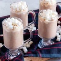 Four mugs of Instant Pot Hot Chocolate with marshmallows on a serving tray.