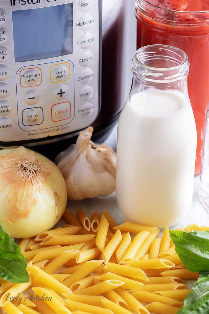 Onions, garlic, cream, tomato puree, penne, and basil used in a vodka sauce recipe.