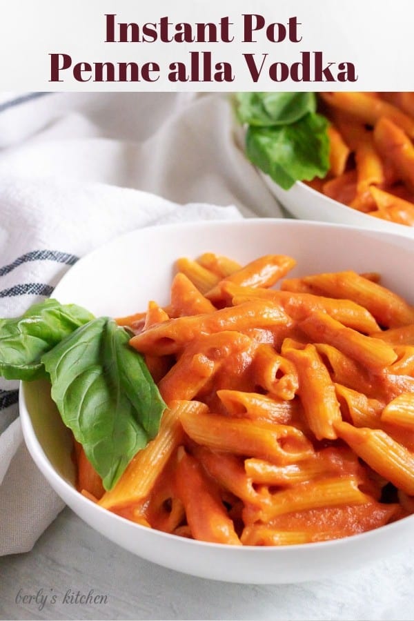 Pinterest photo of two white bowls of penne alla vodka.