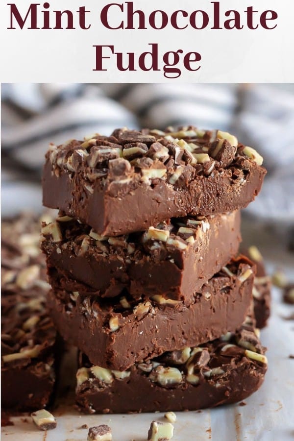 An image for pinterest showing the mint chocolate fudge stacked up on the counter.