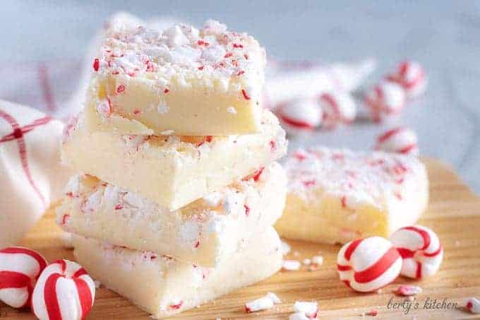 The peppermint fudge, stacked on a cutting board and decorated with peppermint candy.