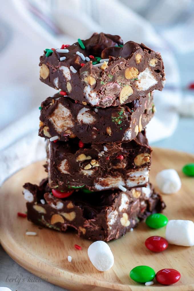 Four pieces of fudge stacked up to show the marshmallows and peanuts.