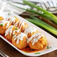 Buffalo Chicken Meatballs covered with ranch dressing.