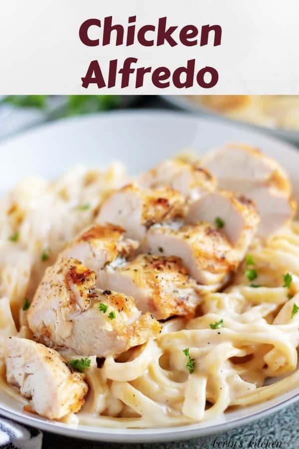 A photo of the chicken alfredo, in a bowl, garnished with parsley.