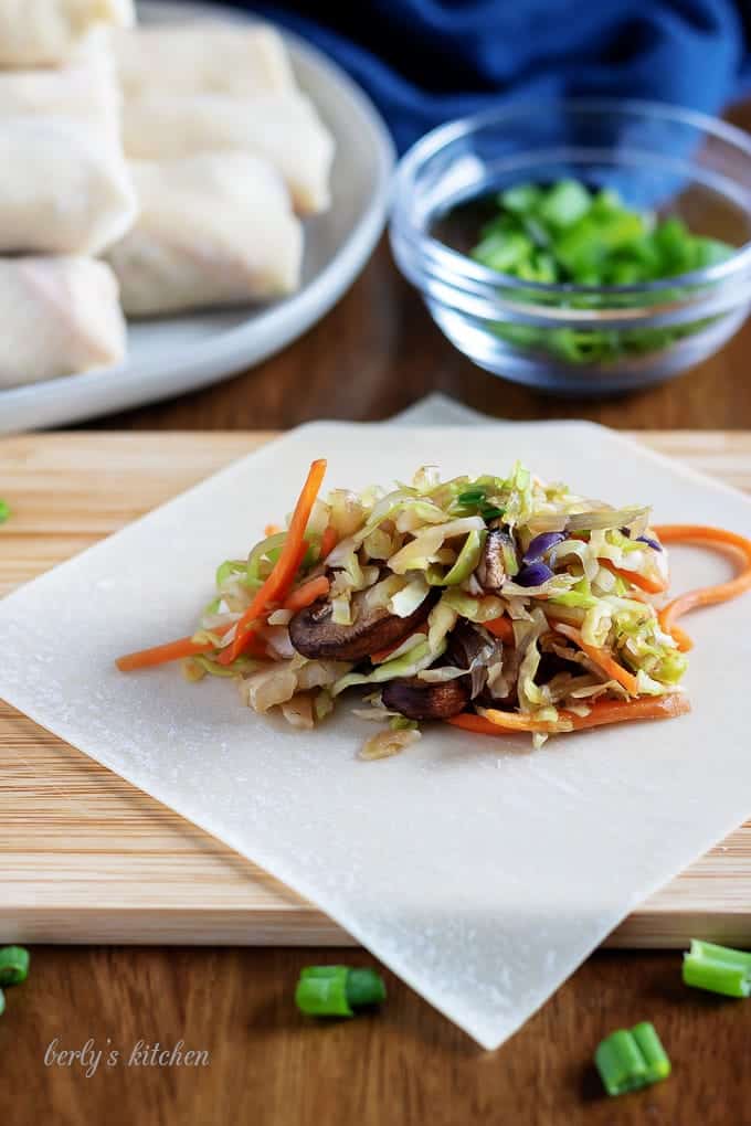 Colorful, cooked vegetable filling placed inside the egg roll wrap.