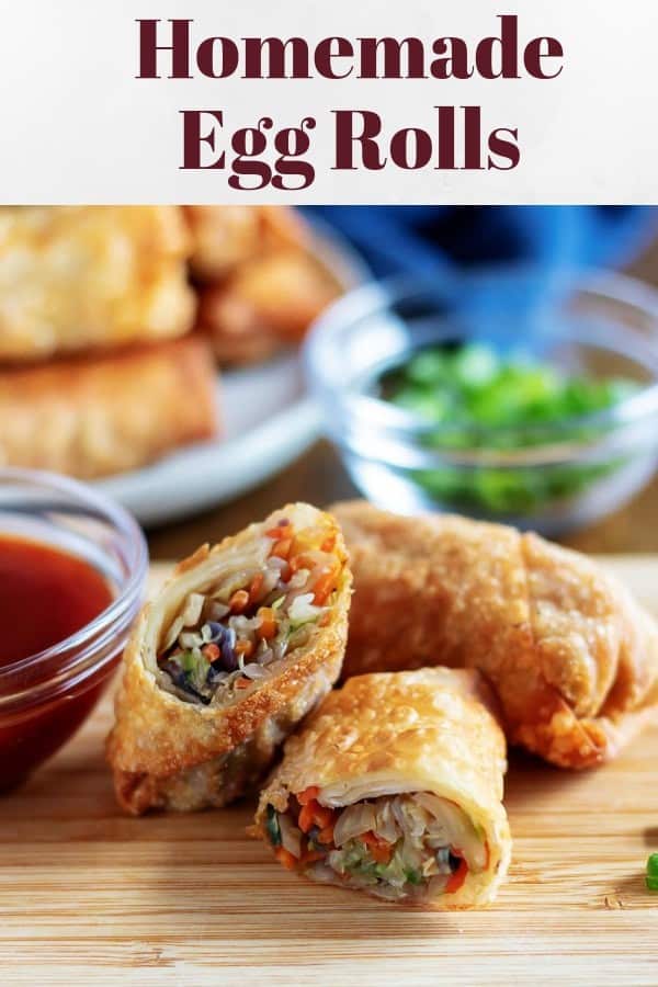 Large photo of the egg rolls, one cut in half, and served with sweet and sour sauce.