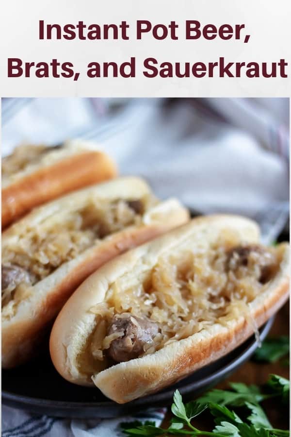 A large photo of the beer brats topped with sauerkraut and onions.