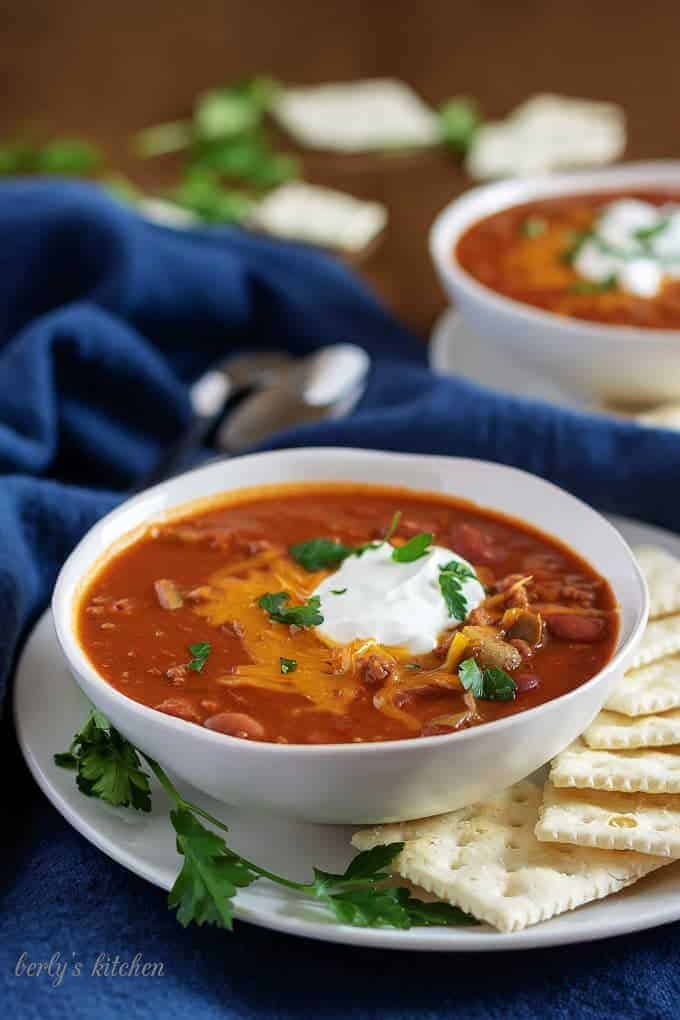 Large photo of the instant pot chili topped cheese and sour cream.