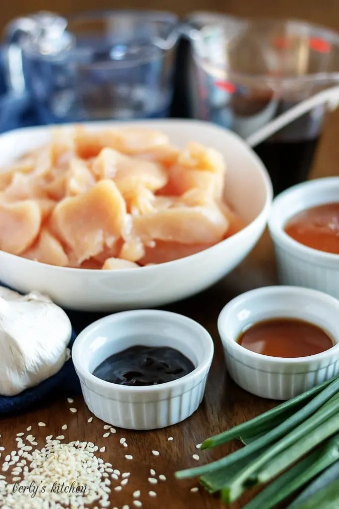 Bowls filled with the honey garlic chicken ingredients, like soy sauce.