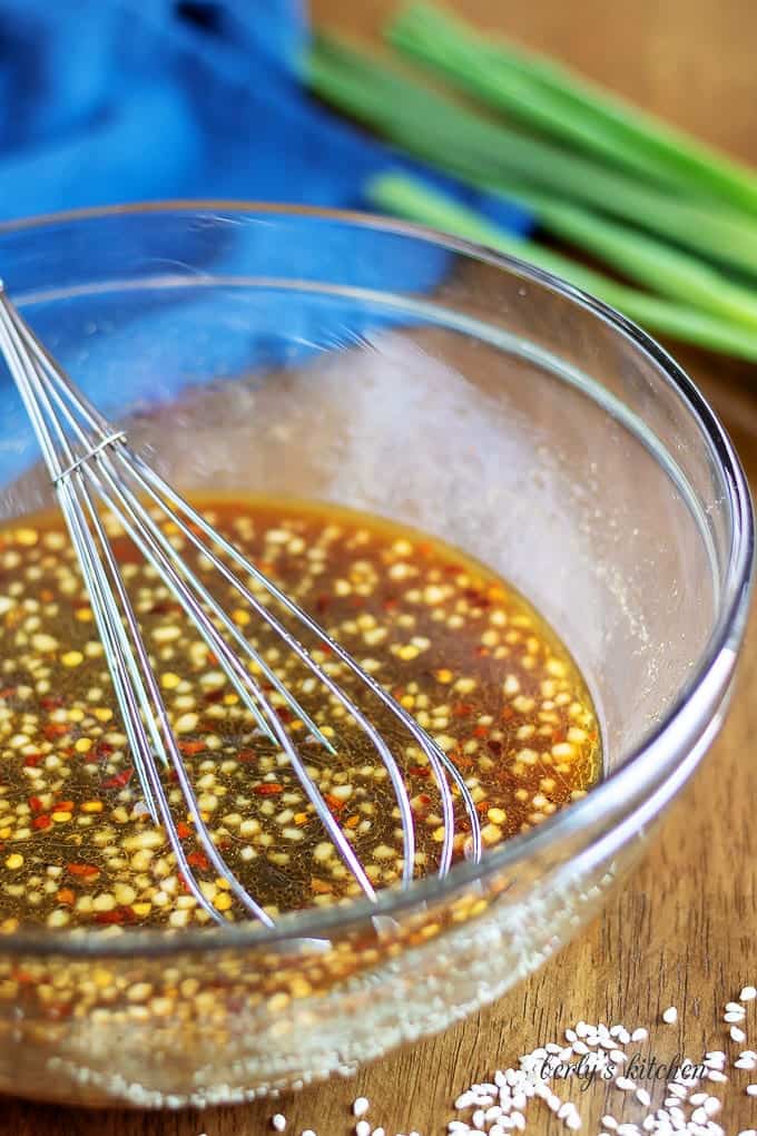 The honey garlic sauce being mixed in a large glass bowl.