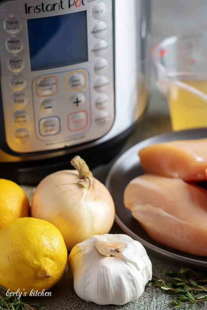 The lemon chicken recipe ingredients like garlic, onions, and fresh lemons.