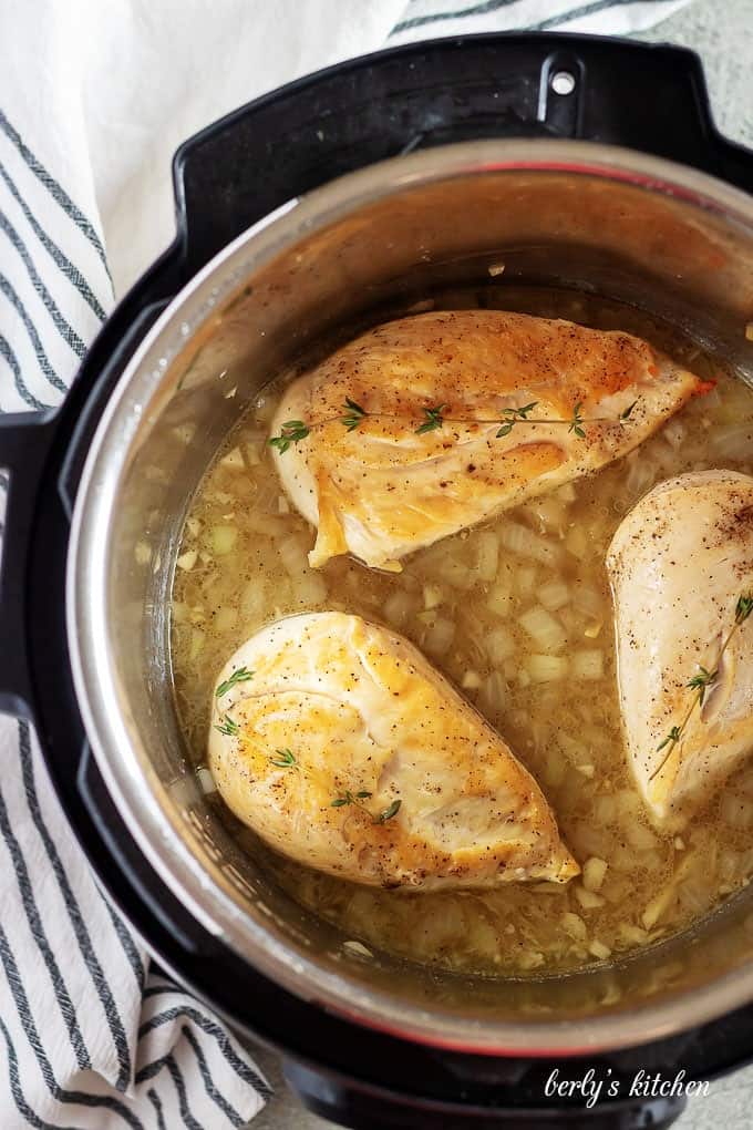 An aerial photo of the cooked chicken breasts in the instant pot.