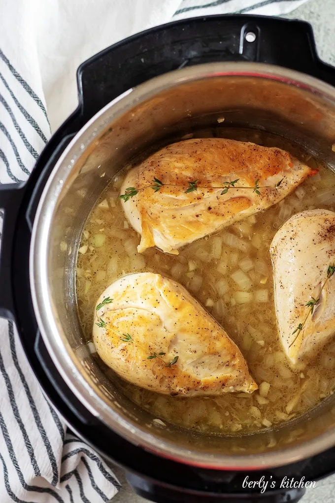 An aerial photo of the cooked chicken breasts in the instant pot.