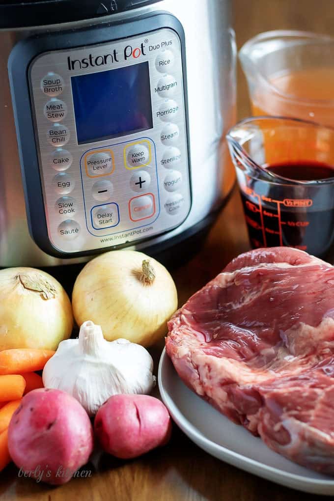 The pot roast recipe ingredients like onions, garlic, red wine, and carrots.