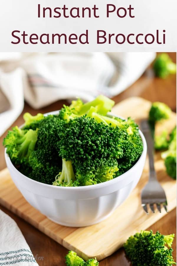 The finished steamed broccoli in a white bowl with a fork.