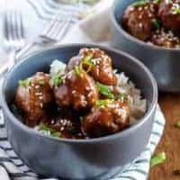 Instant pot teriyaki meatballs with rice in two gray bowls.