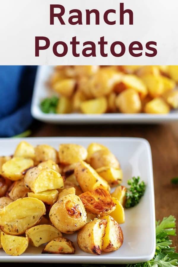 Two square bowls of ranch potatoes, garnished with parsley, for serving.