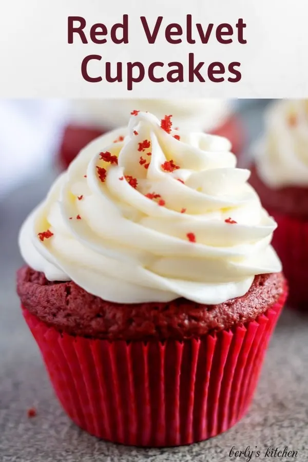 The red velvet cupcake, in a red liner, with cream cheese frosting.