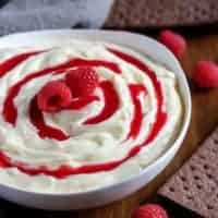 The finished dip, in a bowl, surrounded by graham crackers for dipping.