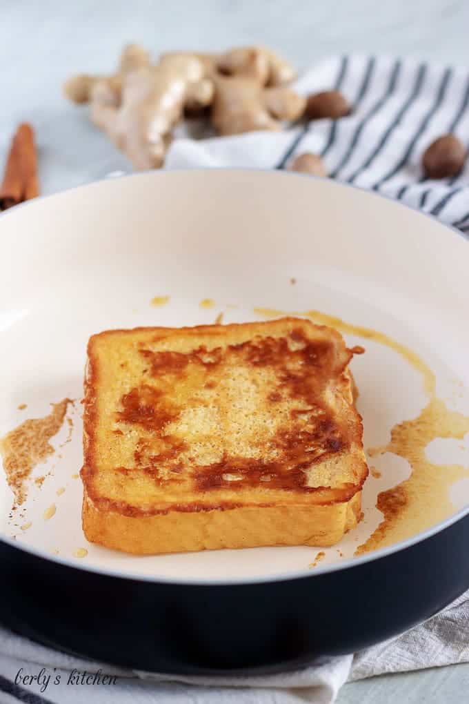 The texas toast being cooked in a non-skillet with butter.