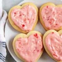 Top down view of 4 cut out sugar cookies on a plate.