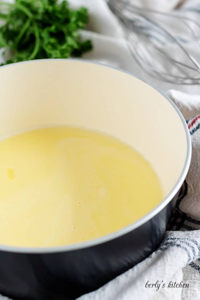 A saucepan showing melted butter and heavy cream mixed together.