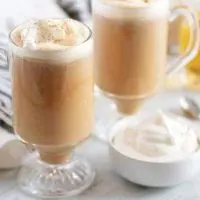 Two Nutty Irishman drinks, in mugs, garnished with homemade whipped cream.