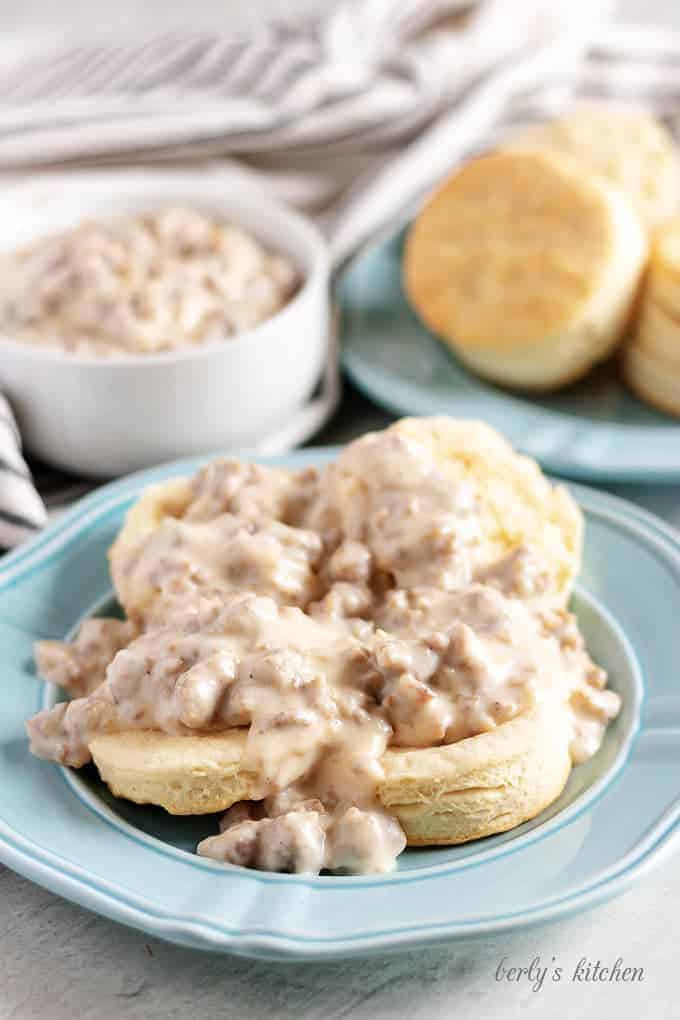 Two homemade biscuits, cut in half, and smothered in sausage gravy.