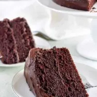 Two slices of the chocolate cake on small white plates.