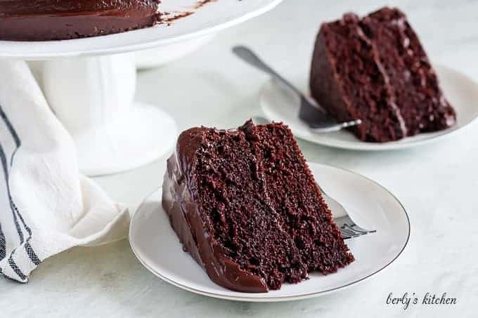 Two slices of the chocolate cake, showing the layers and ganache.