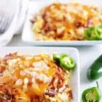 Large photo of the hash browns, smothered in chili and shredded cheese.
